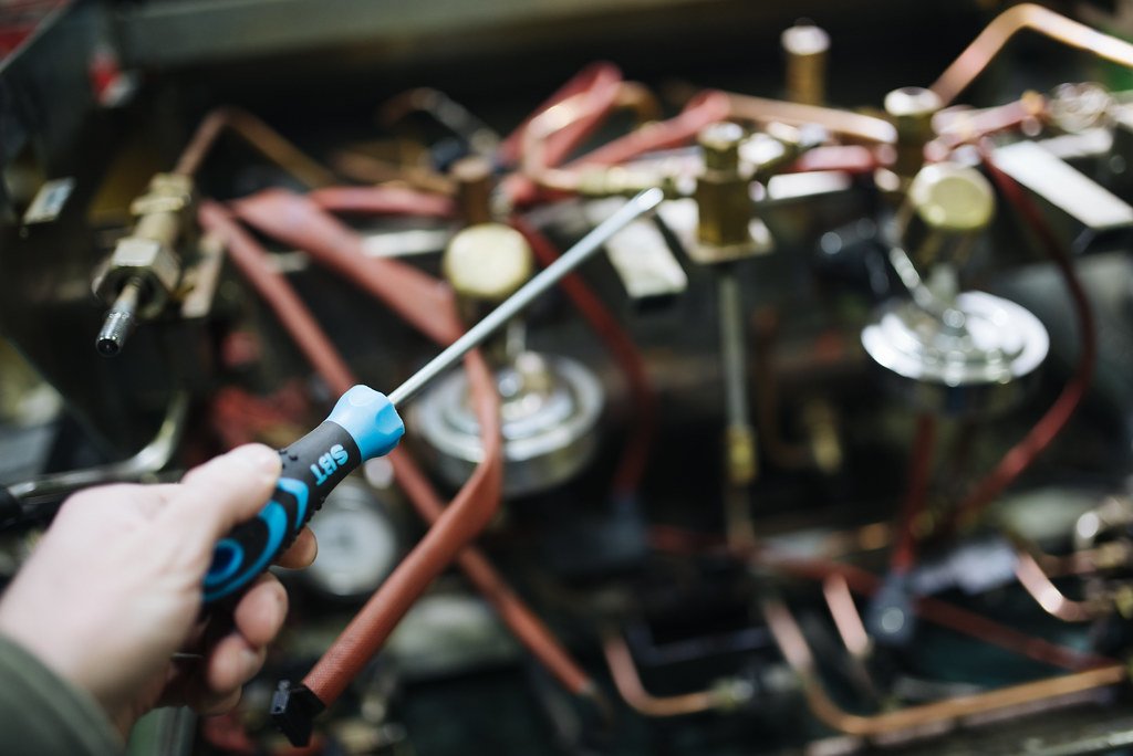 Licensed HVAC technician repairing an air conditioning system in a Glendale, CA home